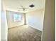 Neutral bedroom featuring a ceiling fan, carpet, and window allowing for lots of natural light at 2749 Invermark St, Henderson, NV 89044