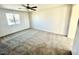 Neutral bedroom featuring a ceiling fan, carpet, and window allowing for lots of natural light at 2749 Invermark St, Henderson, NV 89044