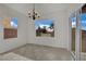 Bright dining area features tile floors, modern chandelier, and backyard views at 2749 Invermark St, Henderson, NV 89044