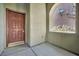 Welcoming front entrance featuring a solid wood door and an arched window with exterior view at 2749 Invermark St, Henderson, NV 89044