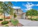 Beautiful two-story home with manicured front yard, mature trees, and a two-car garage at 2749 Invermark St, Henderson, NV 89044