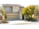 Two-story home with a neutral-colored exterior, attached garage, and easy to maintain landscaping at 2749 Invermark St, Henderson, NV 89044