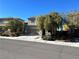 Two-story home with a neutral-colored exterior, attached garage, and easy to maintain landscaping at 2749 Invermark St, Henderson, NV 89044