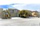 Two story home with a desert landscaped yard, driveway, and two car garage at 2749 Invermark St, Henderson, NV 89044
