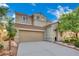 Charming exterior view of a two-story home with a two-car garage and a well-kept front yard at 2749 Invermark St, Henderson, NV 89044