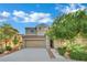Inviting two-story home featuring a well-manicured lawn, mature landscaping, and a two-car garage at 2749 Invermark St, Henderson, NV 89044