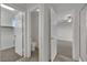Hallway features an open door to a bathroom, closet, and one of the bedrooms with a ceiling fan at 2749 Invermark St, Henderson, NV 89044