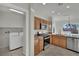 Bright kitchen featuring wooden cabinetry, stainless steel appliances, and a convenient laundry area at 2749 Invermark St, Henderson, NV 89044