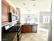 Bright kitchen with wood cabinets, stainless steel appliances, stone counters, and tile floors at 2749 Invermark St, Henderson, NV 89044
