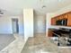 Bright kitchen with wood cabinets, stainless steel appliances, stone counters, and tile floors at 2749 Invermark St, Henderson, NV 89044
