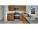 Modern kitchen with stainless steel appliances, granite countertops, and ample cabinet space at 2749 Invermark St, Henderson, NV 89044