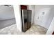 View of stainless refrigerator, tile floors and interior door at 2749 Invermark St, Henderson, NV 89044