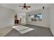 Bright living room with plush carpet, ceiling fan, and large window showcasing backyard at 2749 Invermark St, Henderson, NV 89044