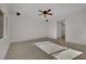 Spacious living room with ceiling fan, with tile and carpet flooring at 2749 Invermark St, Henderson, NV 89044