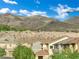 Scenic view overlooking rooftops with mountains in the background under a blue, cloudy sky at 2749 Invermark St, Henderson, NV 89044
