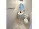 Bathroom featuring tile floors, a pedestal sink, round mirror, and toilet at 2749 Invermark St, Henderson, NV 89044