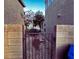 Side yard showing gravel landscaping with secure block and wrought iron fence at 2749 Invermark St, Henderson, NV 89044