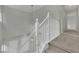 Carpeted staircase with white railings and modern pendant lighting from above at 2749 Invermark St, Henderson, NV 89044