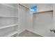 A spacious walk-in closet with built-in shelving and closet rods and a window at 2749 Invermark St, Henderson, NV 89044