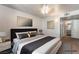 Bedroom with a queen bed, carpet, nightstands, and artwork at 3066 Tarpon Dr # 204, Las Vegas, NV 89120