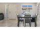Bright dining area with table, complemented by a window, door, and sleek tile floors at 3066 Tarpon Dr # 204, Las Vegas, NV 89120