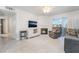 Open-concept living room with white tile flooring and modern fireplace at 3066 Tarpon Dr # 204, Las Vegas, NV 89120