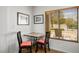 Charming breakfast nook with a mosaic table, cushioned chairs, and a sunny window view at 3128 Faiss Dr, Las Vegas, NV 89134