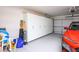 Organized garage featuring ample built-in storage and a stylish red car parked inside at 3128 Faiss Dr, Las Vegas, NV 89134