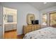 Bright main bedroom offers wood-look floors, a charming bay window, and a dresser with a vanity mirror at 3128 Faiss Dr, Las Vegas, NV 89134
