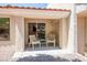 Relaxing outdoor patio featuring neutral decor, tiled roofing, and comfortable seating at 3128 Faiss Dr, Las Vegas, NV 89134
