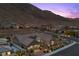 Breathtaking aerial view of the home and surrounding landscape, set against a mountain backdrop at 3131 Reverence Heights Ln, Las Vegas, NV 89138