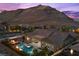 A stunning backyard with a pool, spa, and mountain views, creating a private retreat for relaxation and enjoyment at 3131 Reverence Heights Ln, Las Vegas, NV 89138
