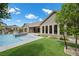 Beautiful backyard featuring a sparkling pool, lush lawn, and seamless transition to indoor living spaces at 3131 Reverence Heights Ln, Las Vegas, NV 89138