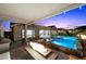 Charming backyard featuring a sparkling pool with sun loungers, a fire pit, and an elegant patio at 3131 Reverence Heights Ln, Las Vegas, NV 89138