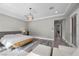Bright bedroom features a decorative light fixture, light wood floors, and a sitting area at 3131 Reverence Heights Ln, Las Vegas, NV 89138