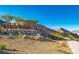 Welcoming entrance to the Reverence community with stone accents, desert landscaping, and scenic mountain views at 3131 Reverence Heights Ln, Las Vegas, NV 89138