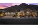 Stunning exterior of single Gathering home featuring a mountain backdrop, lush landscaping, and a two car garage at 3131 Reverence Heights Ln, Las Vegas, NV 89138