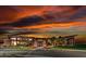 Striking exterior showcasing modern architecture and a vibrant sunset, creating a visually stunning and luxurious ambiance at 3131 Reverence Heights Ln, Las Vegas, NV 89138