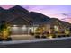 Beautiful home exterior featuring desert landscaping, two-car garage, and mountain views at 3131 Reverence Heights Ln, Las Vegas, NV 89138