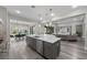 Well-appointed kitchen features a large island with seating, stainless appliances, and open concept design at 3131 Reverence Heights Ln, Las Vegas, NV 89138