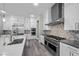 Modern kitchen features stainless steel appliances, stylish backsplash, and open design at 3131 Reverence Heights Ln, Las Vegas, NV 89138