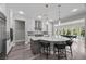 Modern kitchen features a large island with seating and pendant lighting at 3131 Reverence Heights Ln, Las Vegas, NV 89138