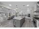 Open kitchen features stainless steel appliances, a spacious island, and flows into the living area at 3131 Reverence Heights Ln, Las Vegas, NV 89138