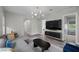 Spacious living room offers a modern light fixture, large television, and comfortable sectional at 3131 Reverence Heights Ln, Las Vegas, NV 89138