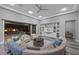 Comfortable living area features a large sectional, chairs, and access to a lovely outdoor pool area at 3131 Reverence Heights Ln, Las Vegas, NV 89138