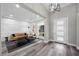 Bright living room featuring a comfortable sofa, modern decor, and beautiful wood floors at 3131 Reverence Heights Ln, Las Vegas, NV 89138