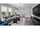 Bright living room features a comfortable sectional, neighborhood views, and sleek decor at 3131 Reverence Heights Ln, Las Vegas, NV 89138