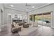 Bright, open living room features a comfortable sofa, stylish chairs, and access to the outdoor living area at 3131 Reverence Heights Ln, Las Vegas, NV 89138