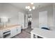Well-lit office space featuring modern light fixture, white cabinets, and gray wood flooring at 3131 Reverence Heights Ln, Las Vegas, NV 89138