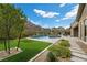 Gorgeous backyard showcasing a modern pool, well-maintained lawn, and elegant landscaping at 3131 Reverence Heights Ln, Las Vegas, NV 89138